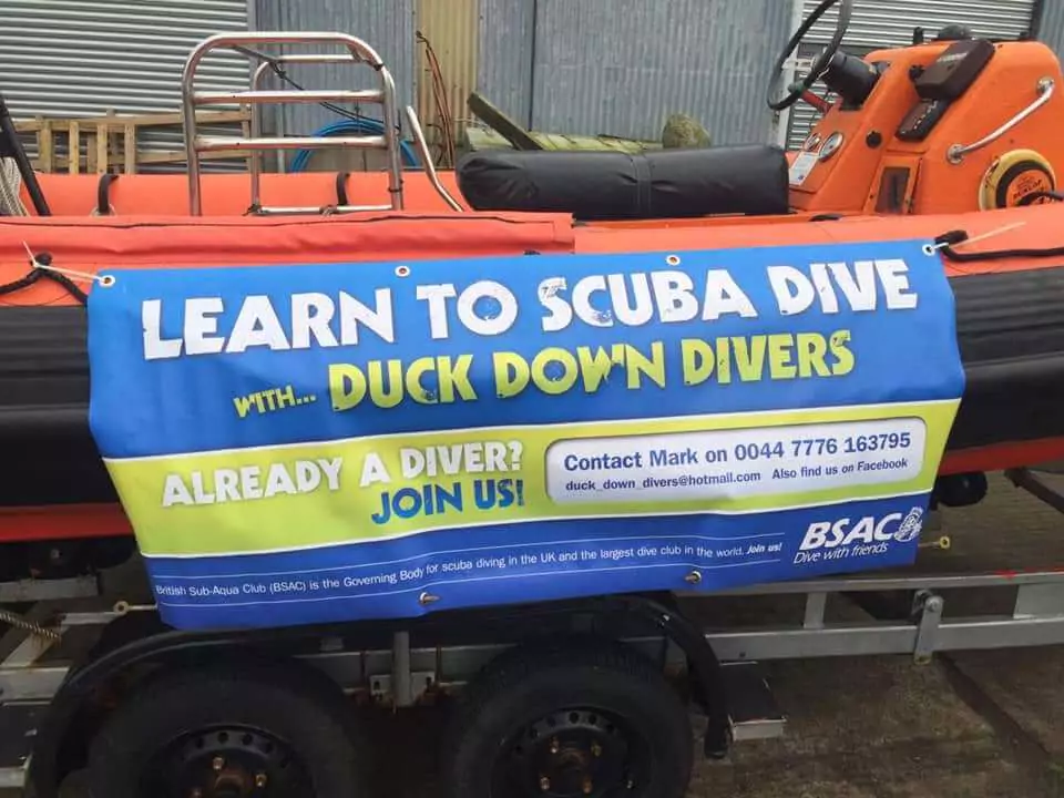 Duck Down Divers canvas ad attached to a rib